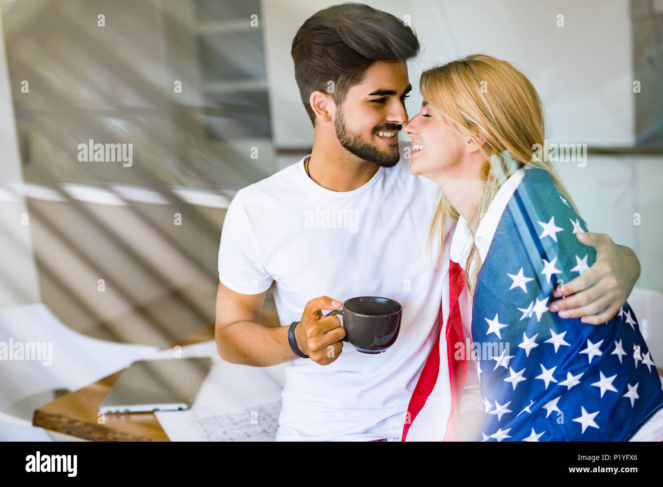 Cute couple hugging and smiling in their home Stock Photo - Alamy