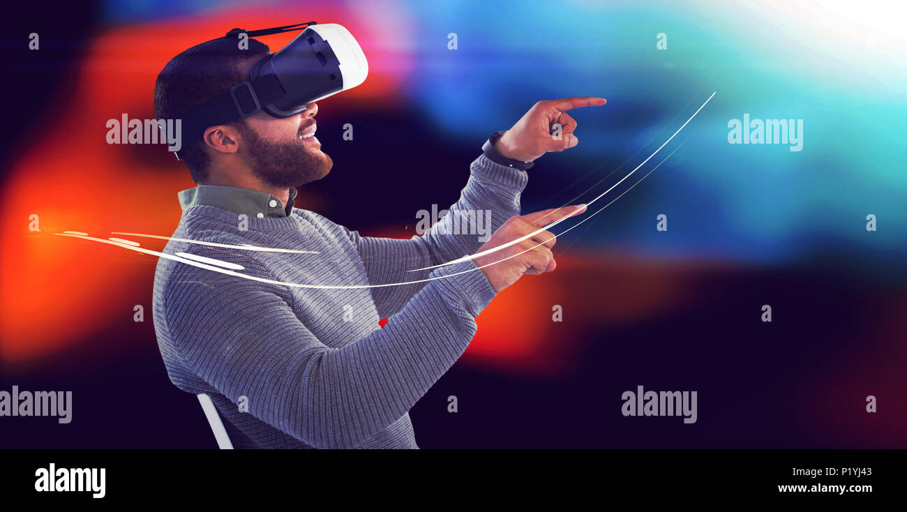 Male executive using virtual reality headset Stock Photo