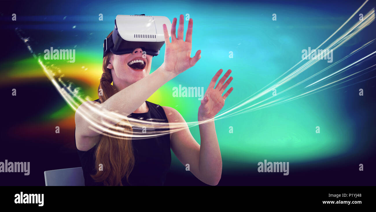 Female executive using virtual reality headset Stock Photo - Alamy