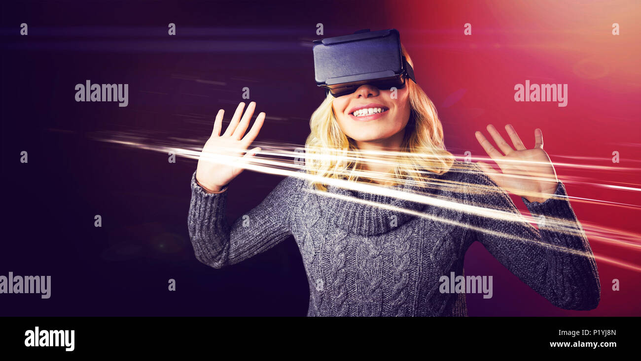 Cheerful young woman using reality virtual headset Stock Photo
