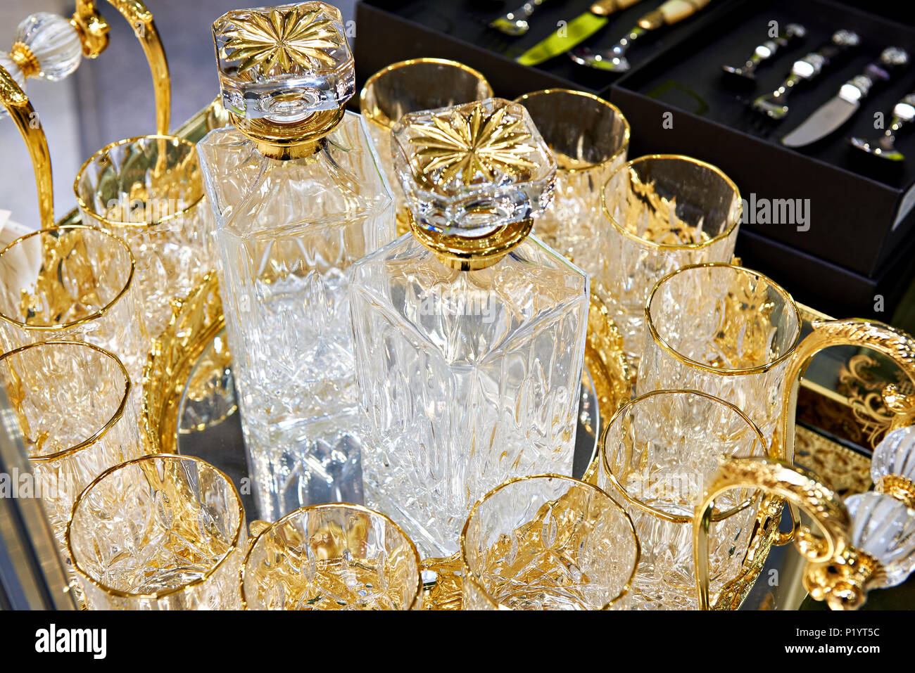 Glass decanters and glasses for drinks decorated with gold Stock Photo