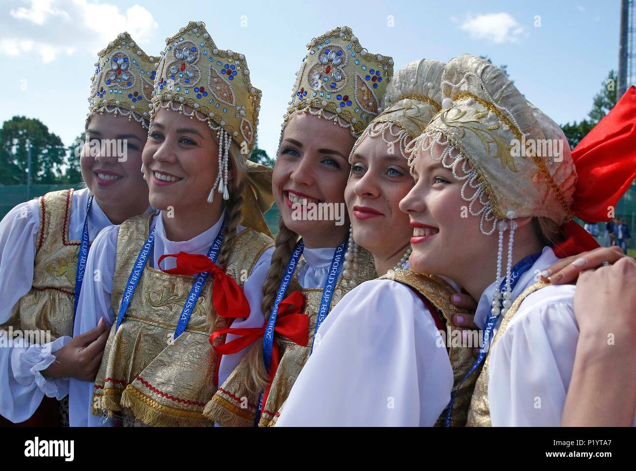 Women pose for a photo in traditional Russian clothing ahead the training session at the Spartak Zelenogorsk Stadium, Repino. PRESS ASSOCIATION Photo. Picture date: Wednesday June 13, 2018. See PA story SOCCER England. Photo credit should read: Owen Humphreys/PA Wire. Stock Photo