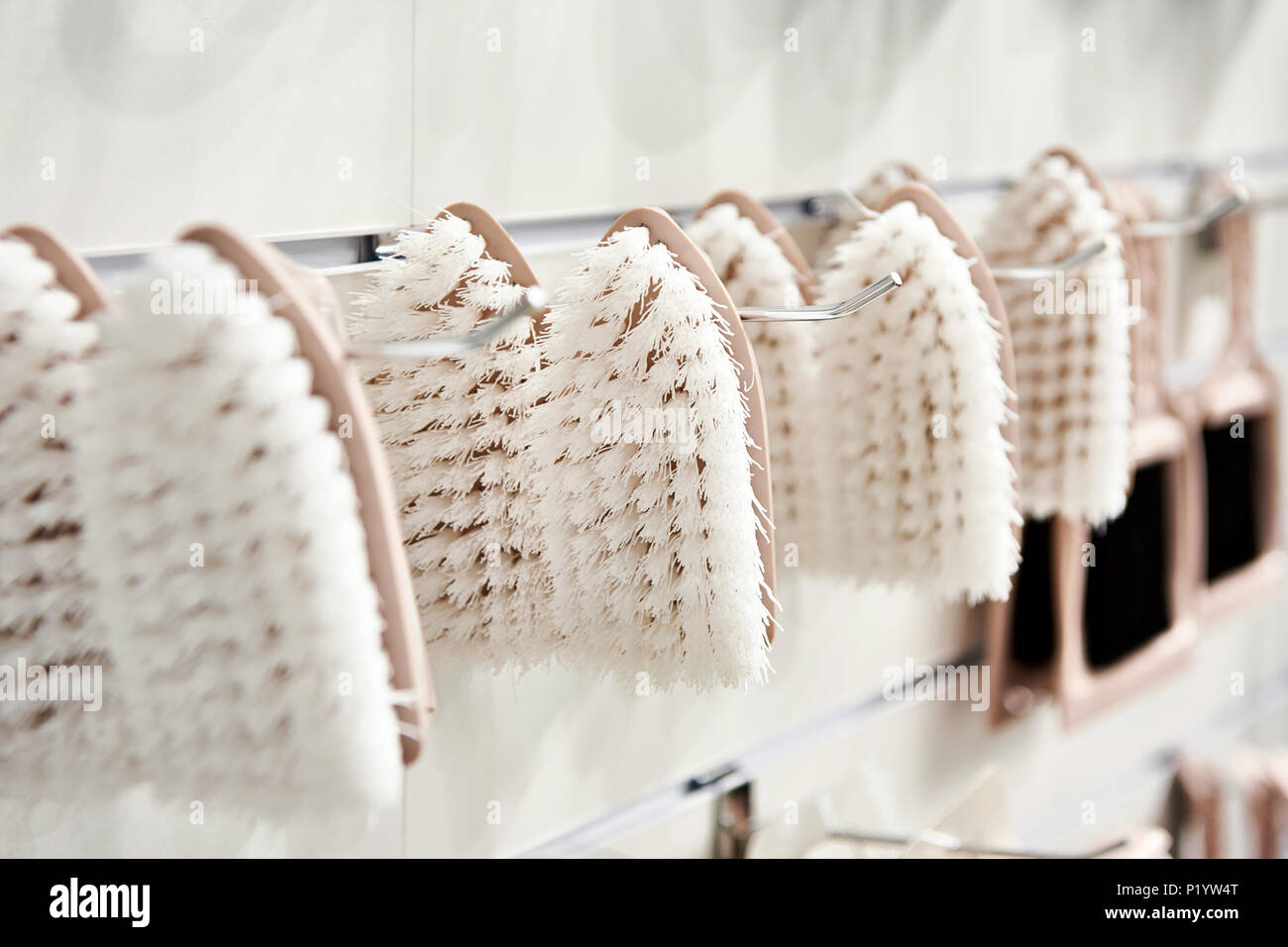 Plastic household brushes in hardware store Stock Photo Alamy