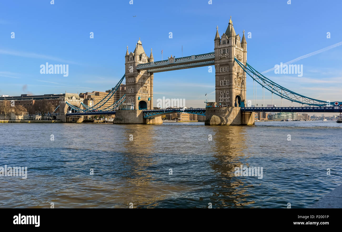 Tower Bridge against the winter blue sky. The bascule and suspension bridge crosses the River Thames and has become an iconic symbol of London. Stock Photo
