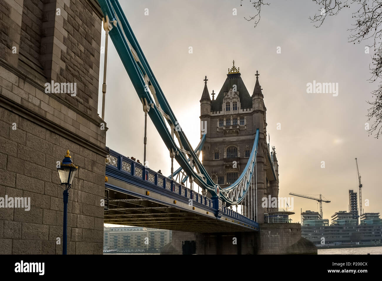 Low angle view of the Tower bridge, London with vintage street lamp. The bascule and suspension bridge crosses the River Thames and has become an icon Stock Photo