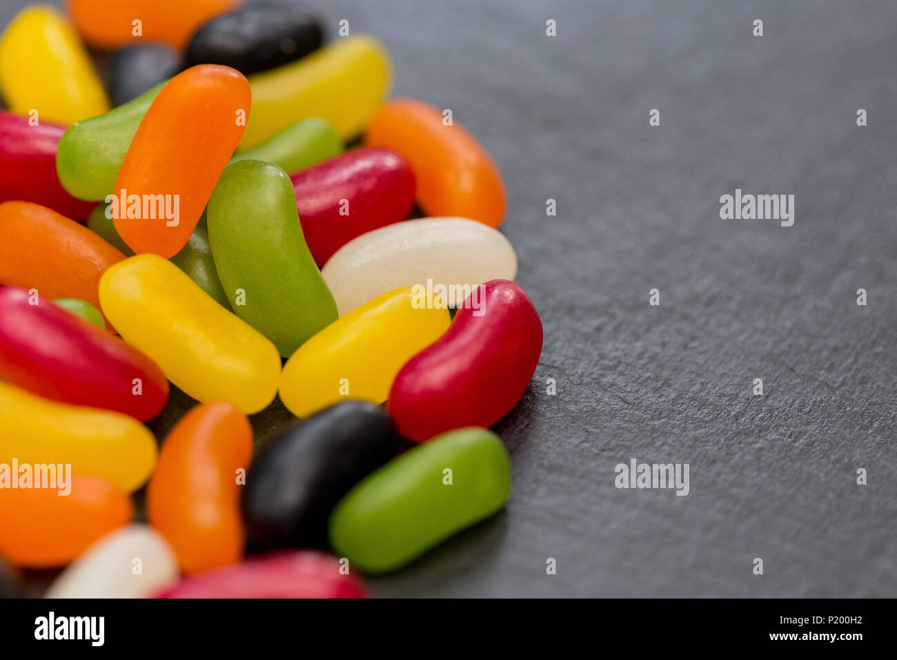 Jelly beans candy sweets on dark background with copy space Stock Photo