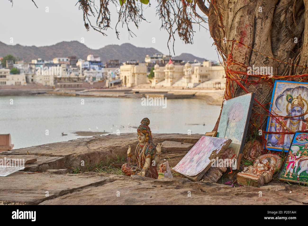 A Hindu shrine shot during the day next to a tree in Pushkar, India. Stock Photo