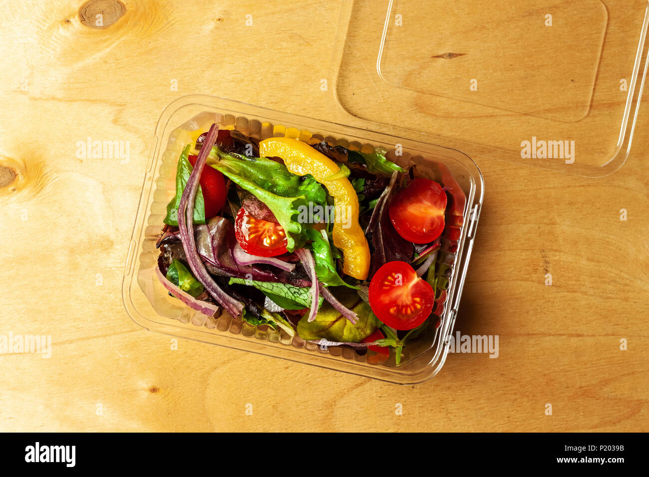 Vegetable salad in a plastic box with plastic fork Stock Photo