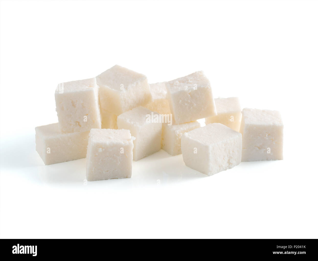 Heap of diced soft cheese isolated on white background Stock Photo