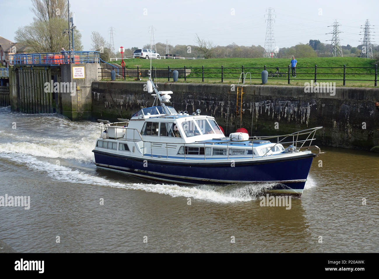 Powerful Nelson 42 motor yacht leaving Preston Dock at high tide on the River Ribble, Lancashire Stock Photo