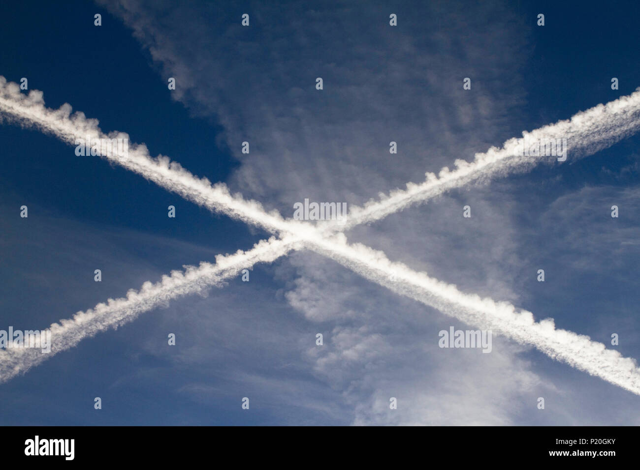Flight paths of two aircrafts in the shape of a cross. Stock Photo