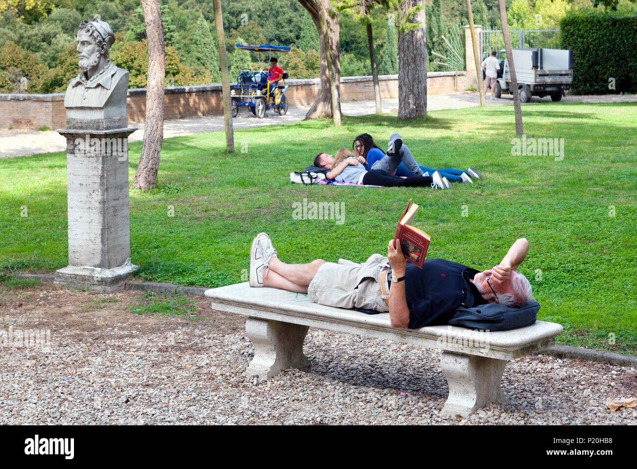 Reading and resting in Villa Borghese Gardens on Pincian Hill, Rome, Italy Stock Photo