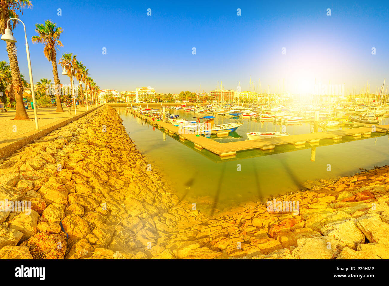 Panorama of yacht and motor boats in Marina de Lagos. The Marina is located in Bay of Lagos, Algarve coast, Portugal, Europe. Summer holidays. Sunset  Stock Photo