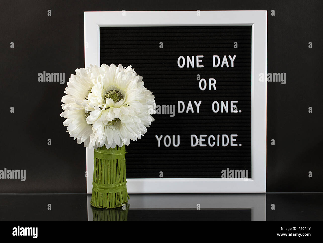 daisy bunch with inspirational message on sign board with reflection Stock Photo