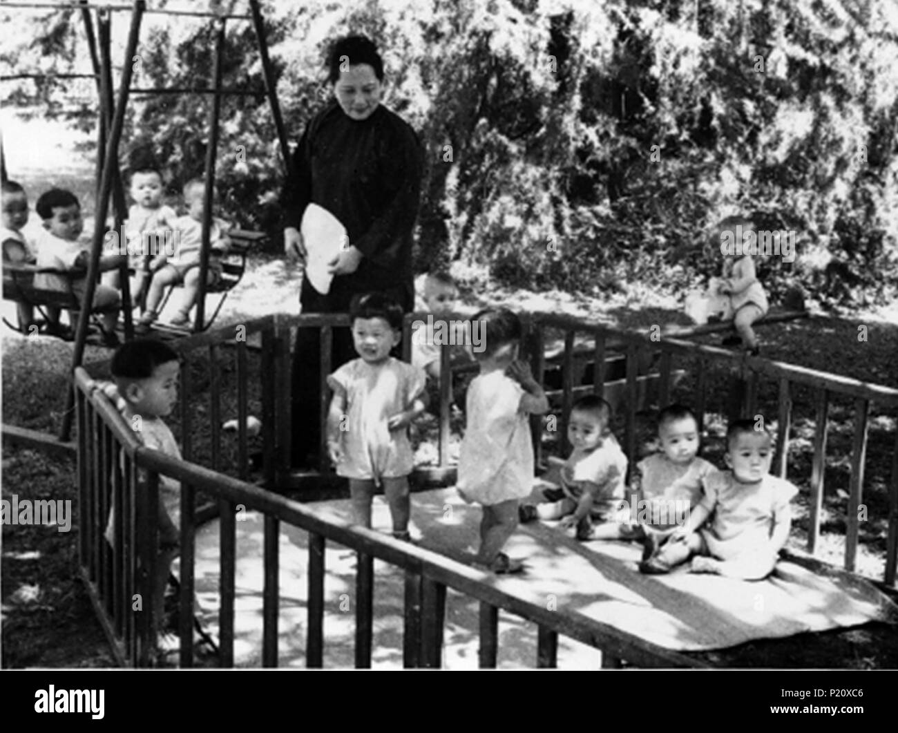 Shanghai. 13th June, 2018. File photo taken in Nov. 1951 shows Soong Ching Ling looking after children at a nursery of the China Welfare Institute (CWI) in Shanghai, east China. This year marks the 80th anniversary of the CWI, founded by Soong Ching Ling in 1938. The Shanghai-based organization focuses on maternal and child health, education and social welfare. Soong Ching Ling, born in Shanghai in 1893, was the wife of Chinese revolutionary Dr. Sun Yat-sen, who led the 1911 Revolution. Credit: CWI/Xinhua/Alamy Live News Stock Photo
