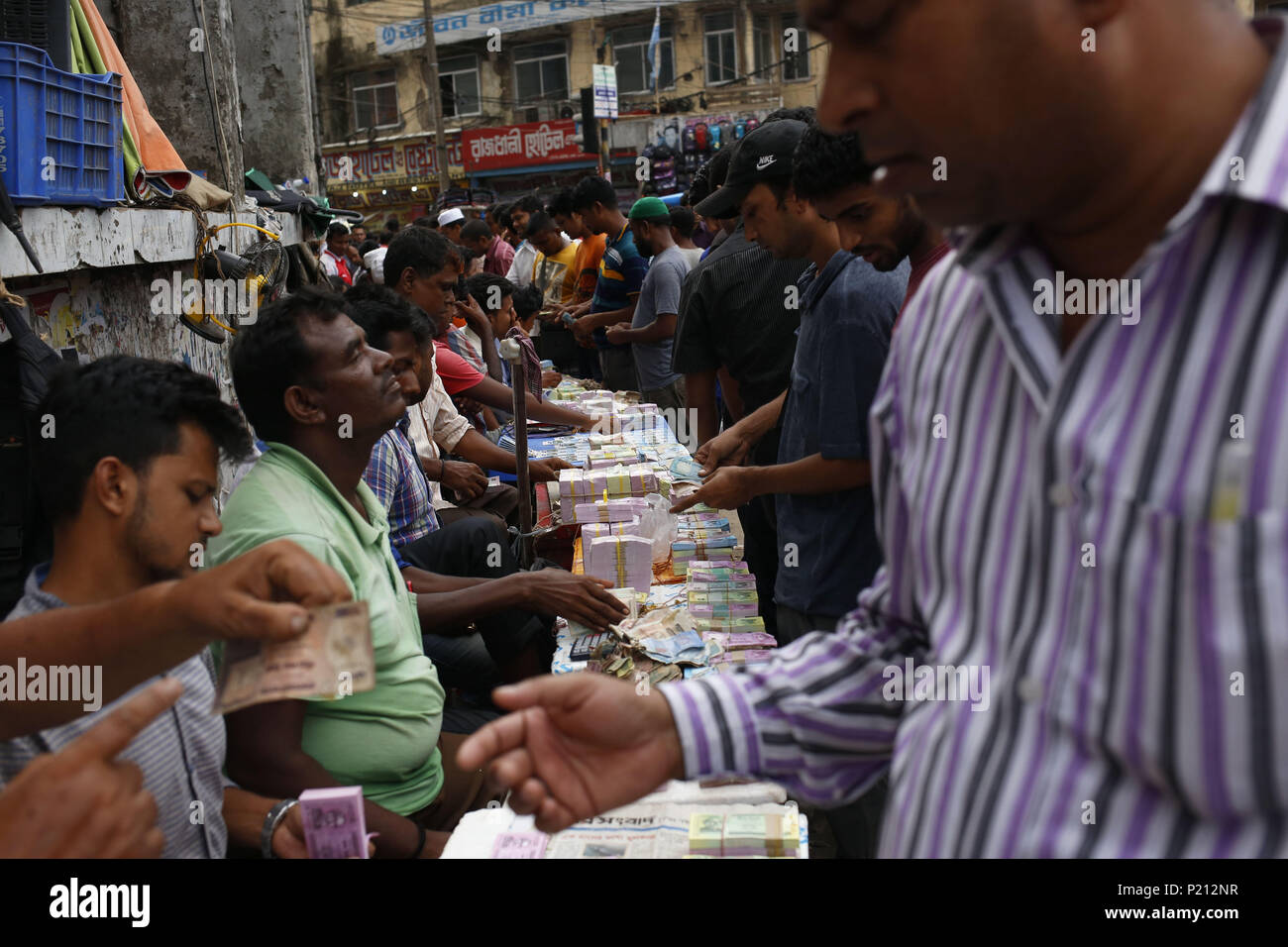 Dhaka, Bangladesh. 11th June, 2018. Street vendors wait for customers as they display fresh bank notes for sale as exchange for a rate of an addition ahead of Eid. Fresh notes demand increase for eid festival as people give for salami (an auspicious token) in Gulistan Avenue. Credit: Md. Mehedi Hasan/ZUMA Wire/Alamy Live News Stock Photo