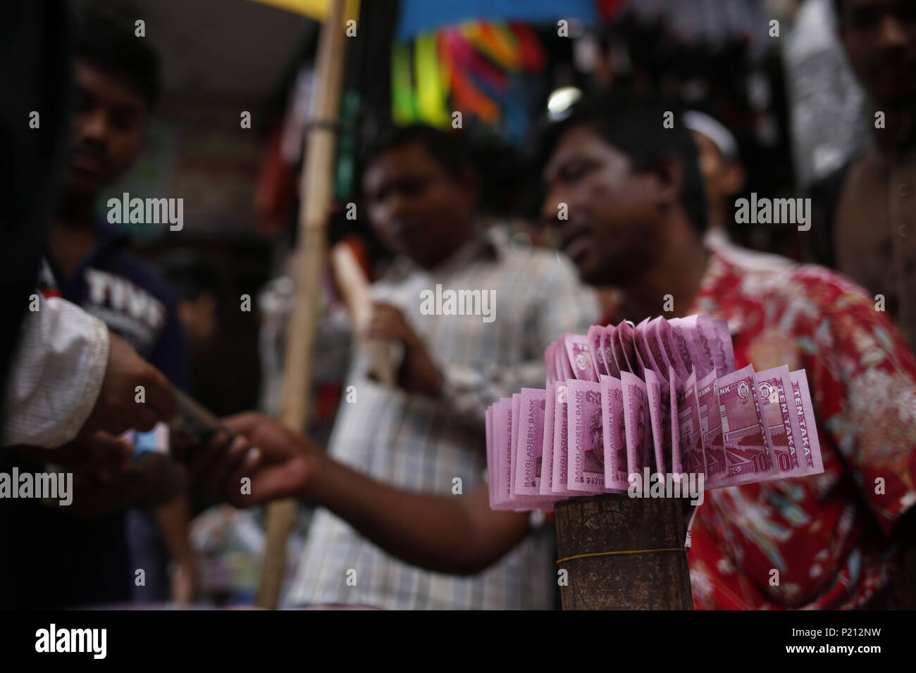 Dhaka, Bangladesh. 13th June, 2018. Street vendors display fresh bank notes for sale as exchange for a rate of an addition ahead of Eid. Fresh notes demand increase for eid festival as people give for salami (an auspicious token) in Gulistan Avenue. Credit: Md. Mehedi Hasan/ZUMA Wire/Alamy Live News Stock Photo