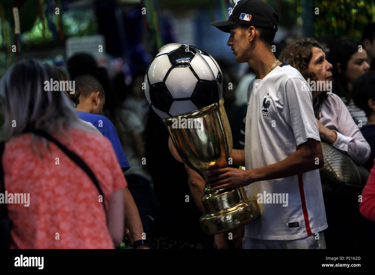 Sao Paulo, June 13. 15th July, 2018. A man holds a trophy at a store in Sao Paulo, Brazil, on June 13, 2018. The Russia 2018 FIFA World Cup will be held from June 14 to July 15, 2018. Credit: Rahel Patrasso/Xinhua/Alamy Live News Stock Photo