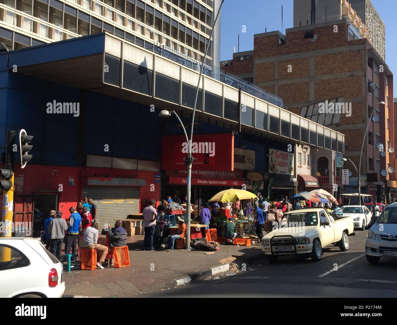 FILED - 24 January 2015, South Africa, Johannesburg: People sit at a busy street crossing in Hillbrow, one of Johannesburg's most dangerous districts. South Africa's economic metropolis is known as one of the most dangerous cities in the country. Now, the metropolis wants to improve its image. Photo: Jürgen Bätz/dpa Stock Photo