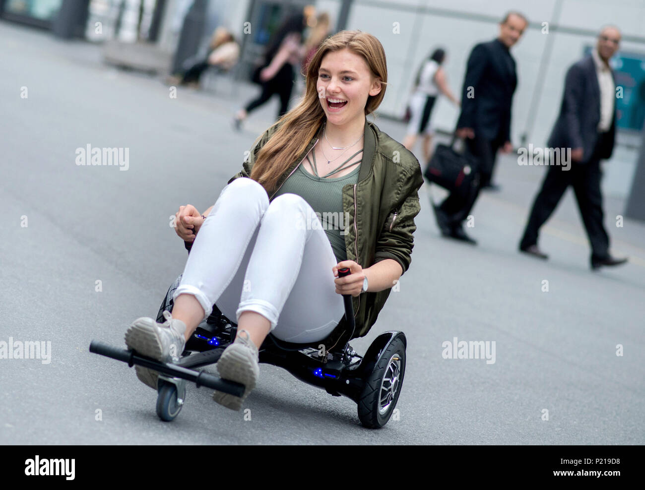 13 June 2018, Germany, Hanover: Julia riding hoverboard with a seat at the fair Cebit. After three decades, Cebit is trying out a 'Festival' format again the 11 and