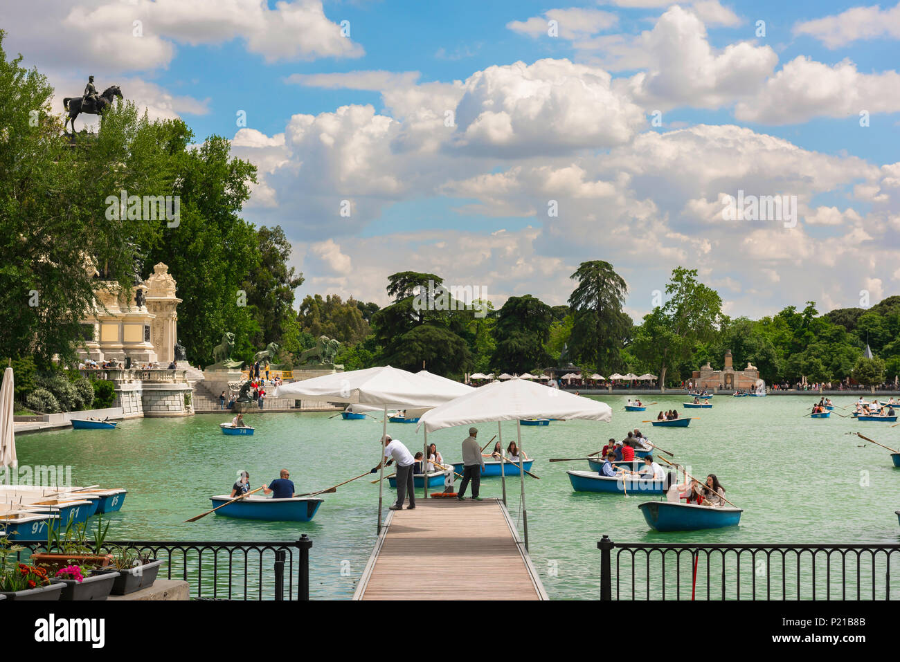 Madrid lake Retiro, view on a summer afternoon of people enjoying boat rides on the Estanque (lake) in the Parque del Retiro in central Madrid, Spain Stock Photo