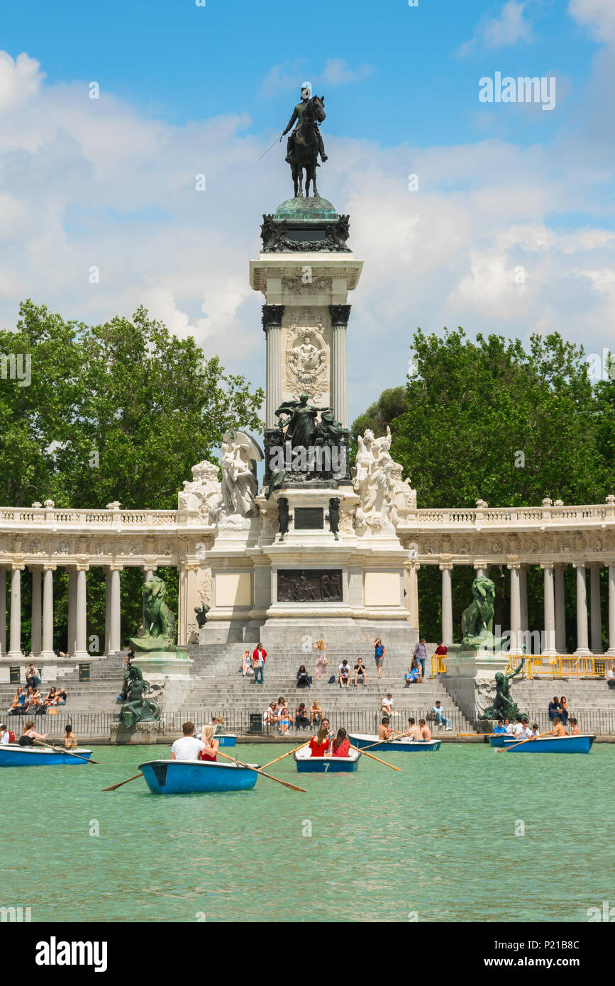 Madrid park Retiro, view on a summer afternoon of people enjoying boat rides on the Estanque (lake) in the Parque del Retiro in central Madrid, Spain Stock Photo
