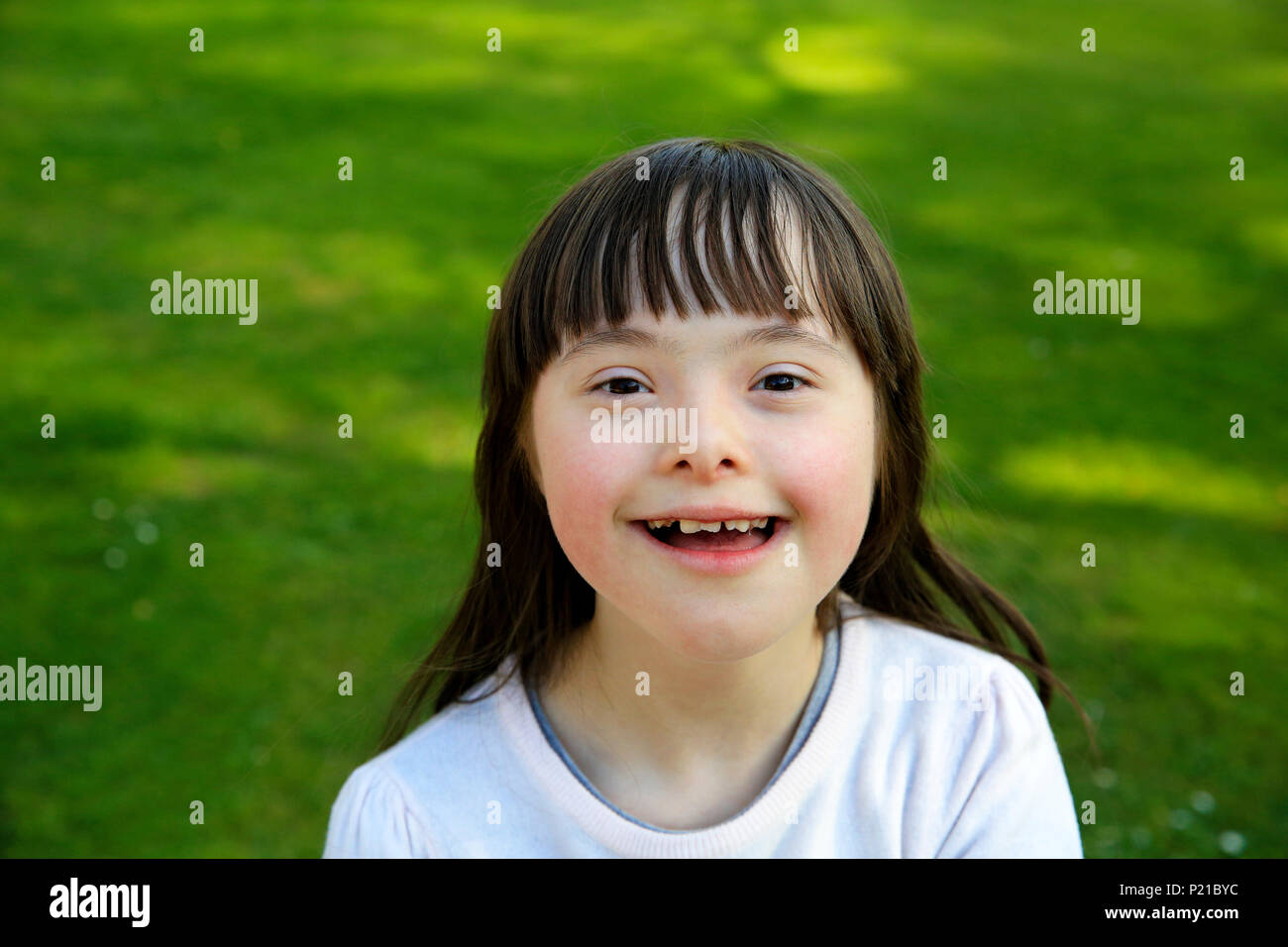Portrait of little girl smiling outside Stock Photo - Alamy