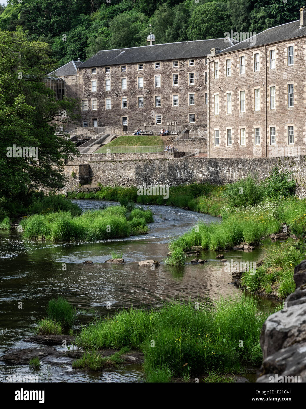 The New Lanark World Heritage Site a unique 18th century mill village sitting alongside the picturesque River Clyde in Scotland Stock Photo