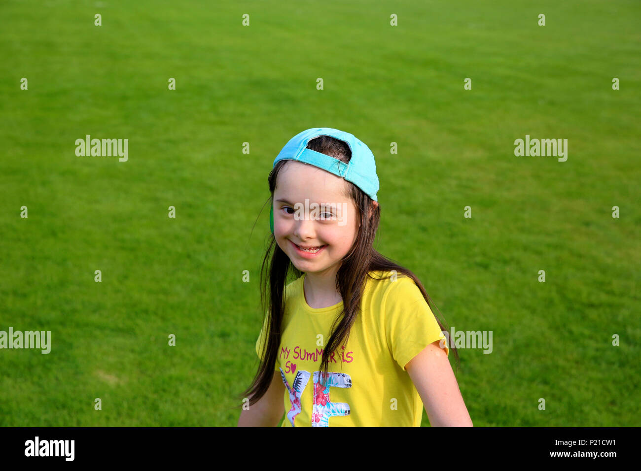 Young girl on the background of green grass Stock Photo