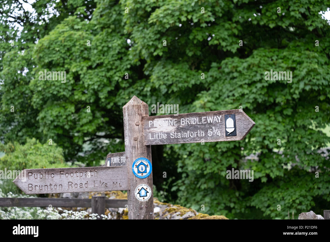 A wooden signpost shows the way to Little Stainforth on the Pennine ...