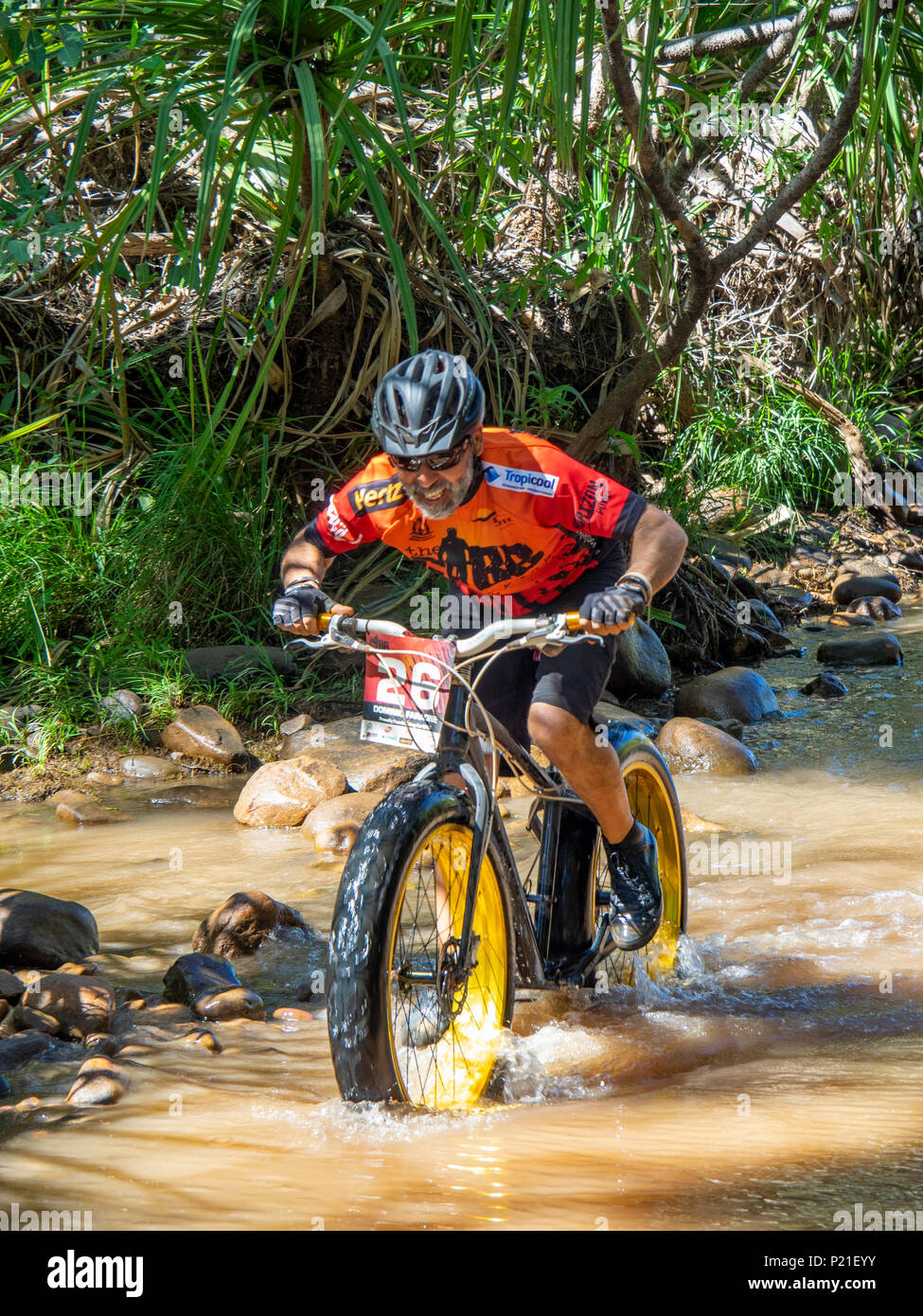 Gibb Challenge 2018 a cyclist on a fatbike crossing the Pentecost River at El Questro Station Kimberley Australia Stock Photo