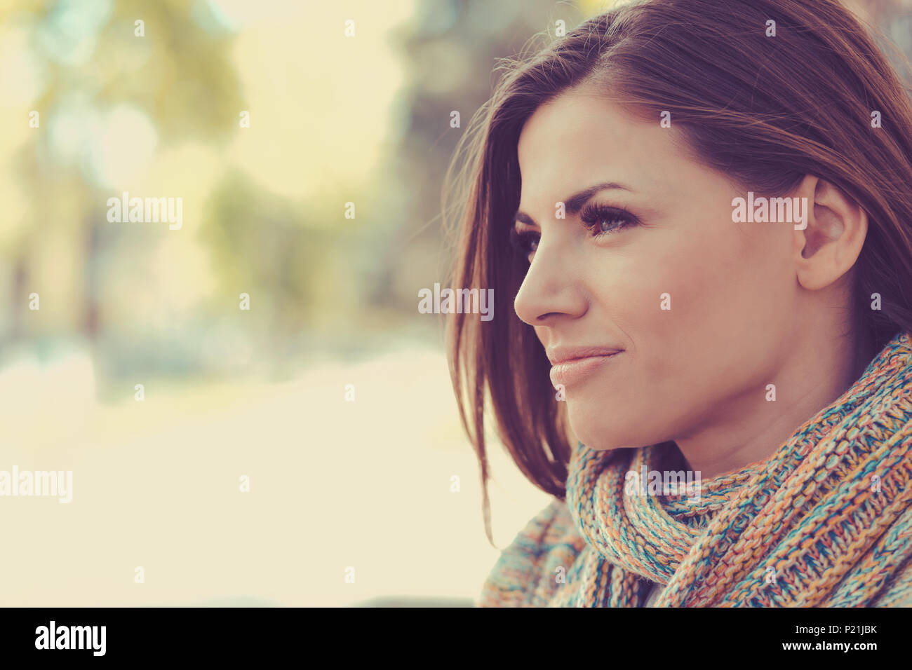 Closeup of a beautiful happy woman on a outdoors city street background Stock Photo