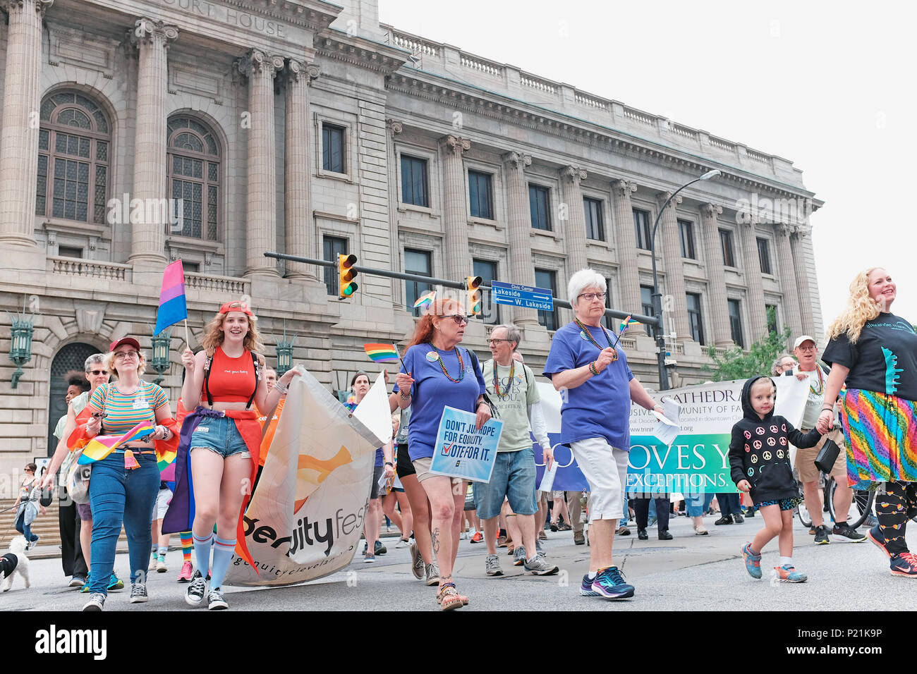 Participants in the 2018 Pride March in Cleveland, Ohio, USA make their way past the historic City Hall and Courthouse in downtown Cleveland. Stock Photo