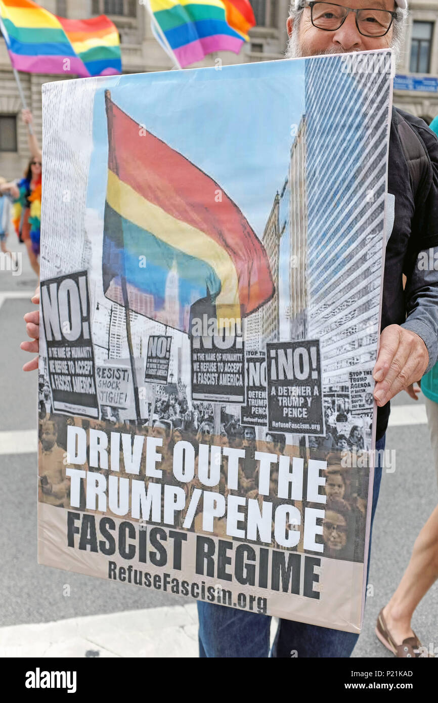Anti-Trump/Pence protestor walks in the 2018 Pride March in downtown Cleveland, Ohio, USA. Stock Photo