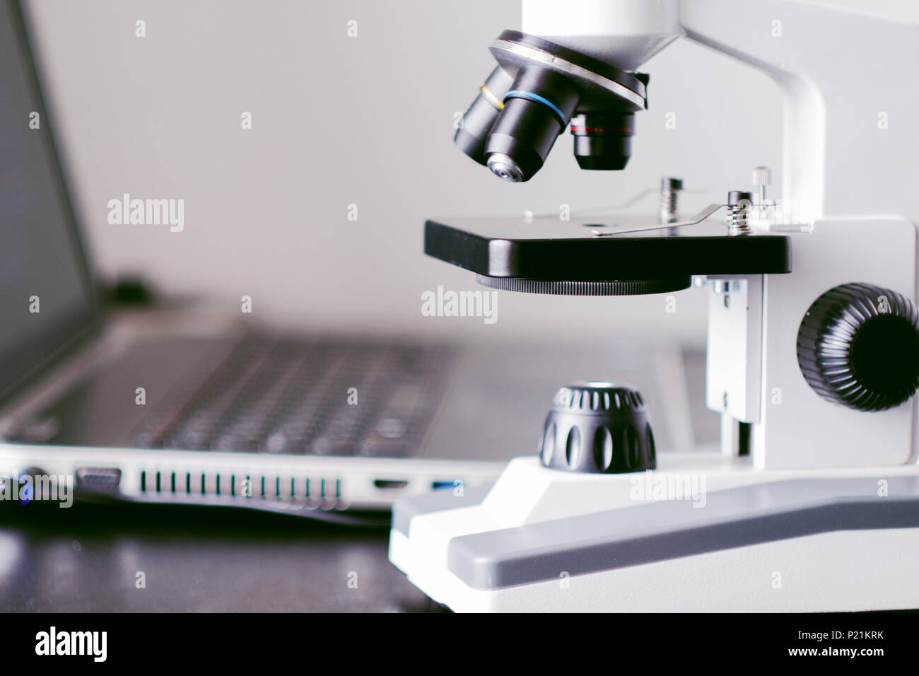 Microscope and laptop on the table. Chemical research, student work in natural Sciences Stock Photo