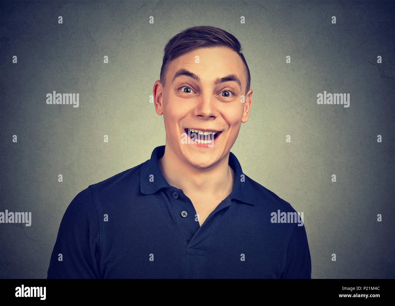 Surprised man looking at camera isolated on gray background Stock Photo