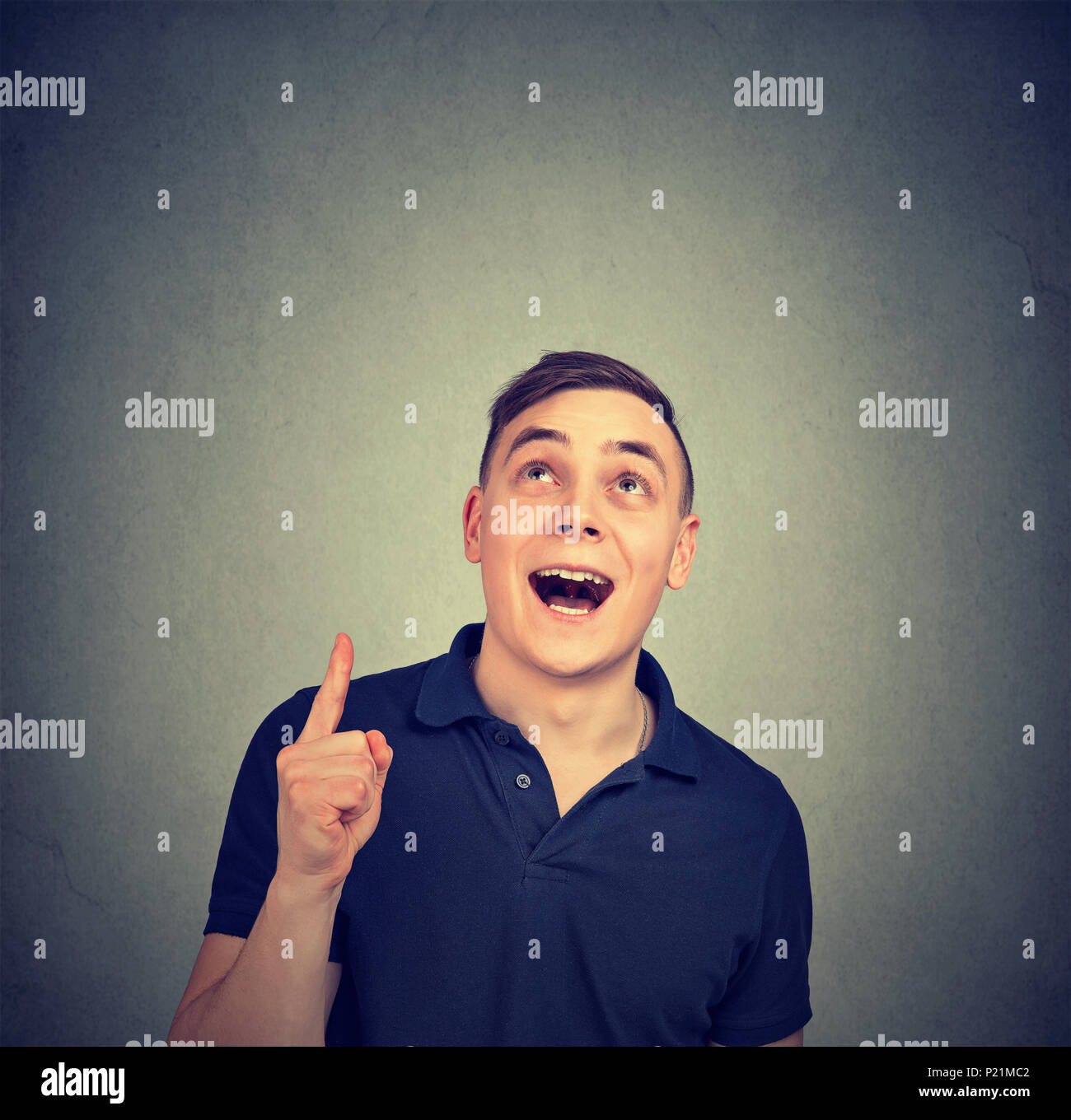 Man has an idea, pointing with finger up. Smart guy solved a problem. Stock Photo
