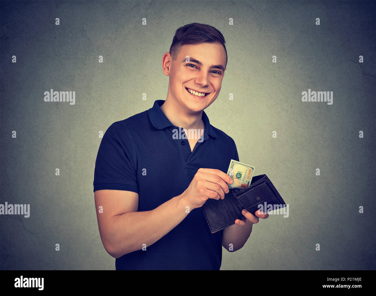 Man takes money out of wallet Stock Photo
