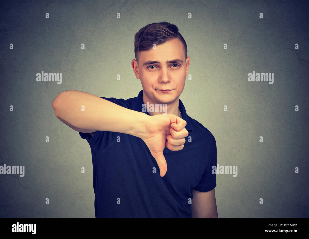 man showing thumb down hand gesture Stock Photo