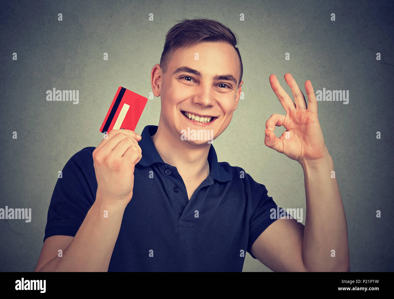Young Casual Man Holding Credit Card Happy With Approved - 