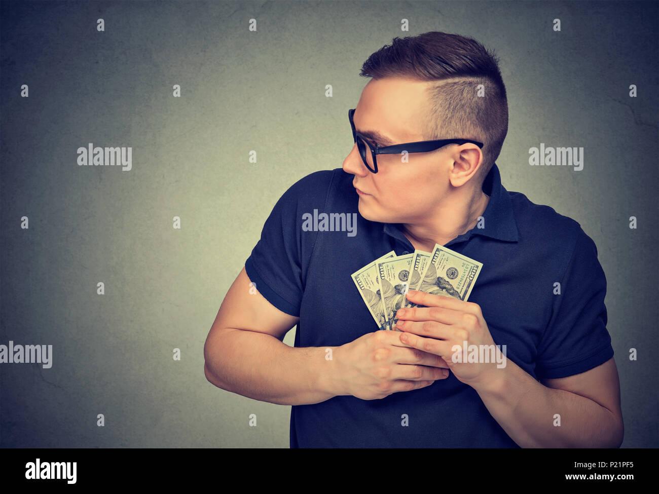 Suspicious greedy man grabbing money Stock Photo