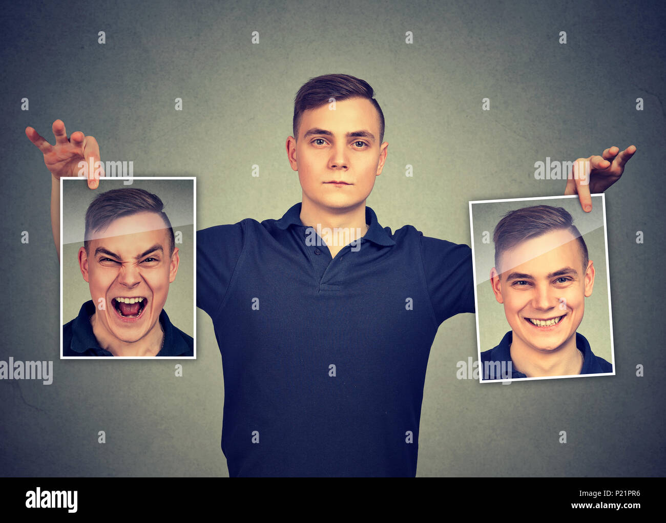 Serious man holding two different face emotion masks of himself Stock Photo