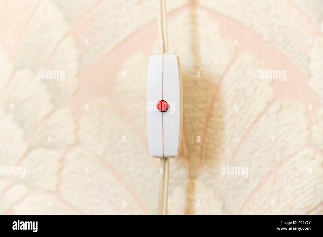 Old fashioned inline on/off switch with red button switch Stock Photo