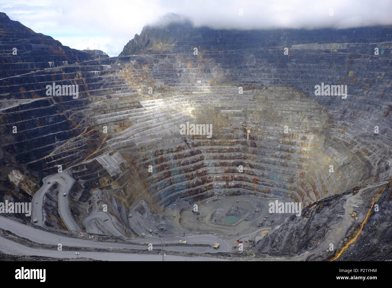 Caterpillar 797B Overburden trucks at the Grasberg Mine in Papua, Indonesia, 2018. At 4500m altitude. Open mine coming towards end of production life Stock Photo