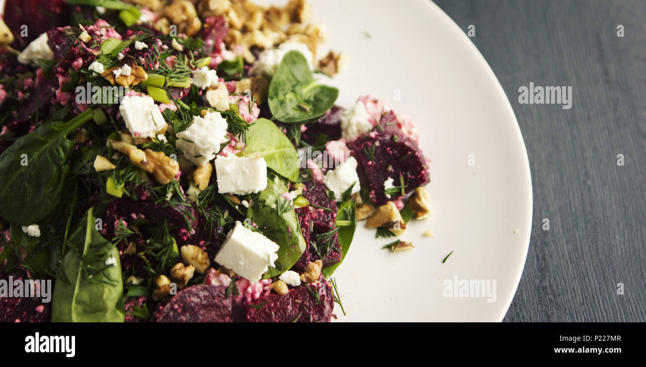 Beetroot salad with cottage cheese, baby spinach and walnuts. European cuisine. Organic food. Vegetarian appetizer. Healthy lifestyle. Simple side dis Stock Photo