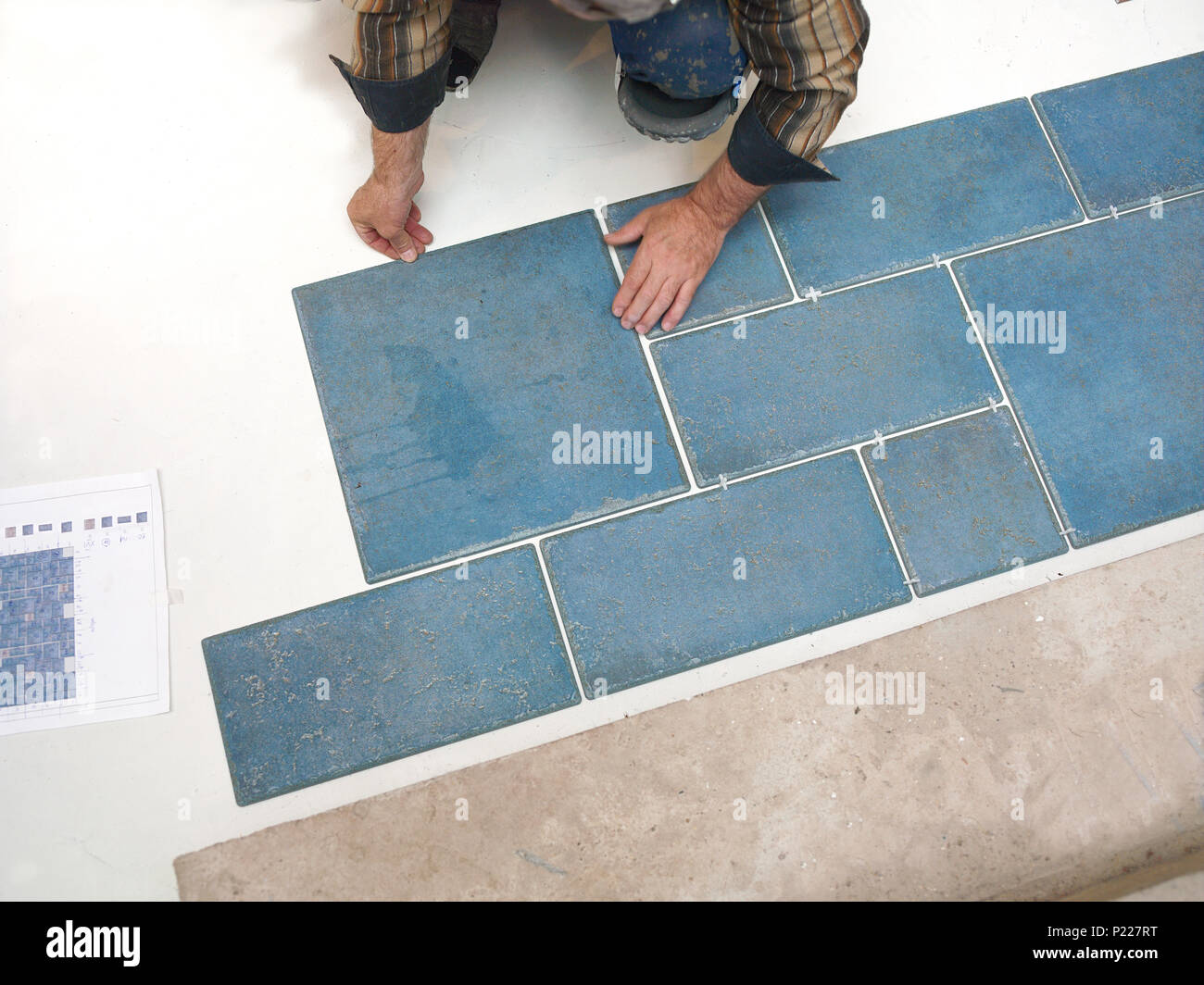 A Tiler Laying Tiles On The Floor Overhead Cropped Shot Stock
