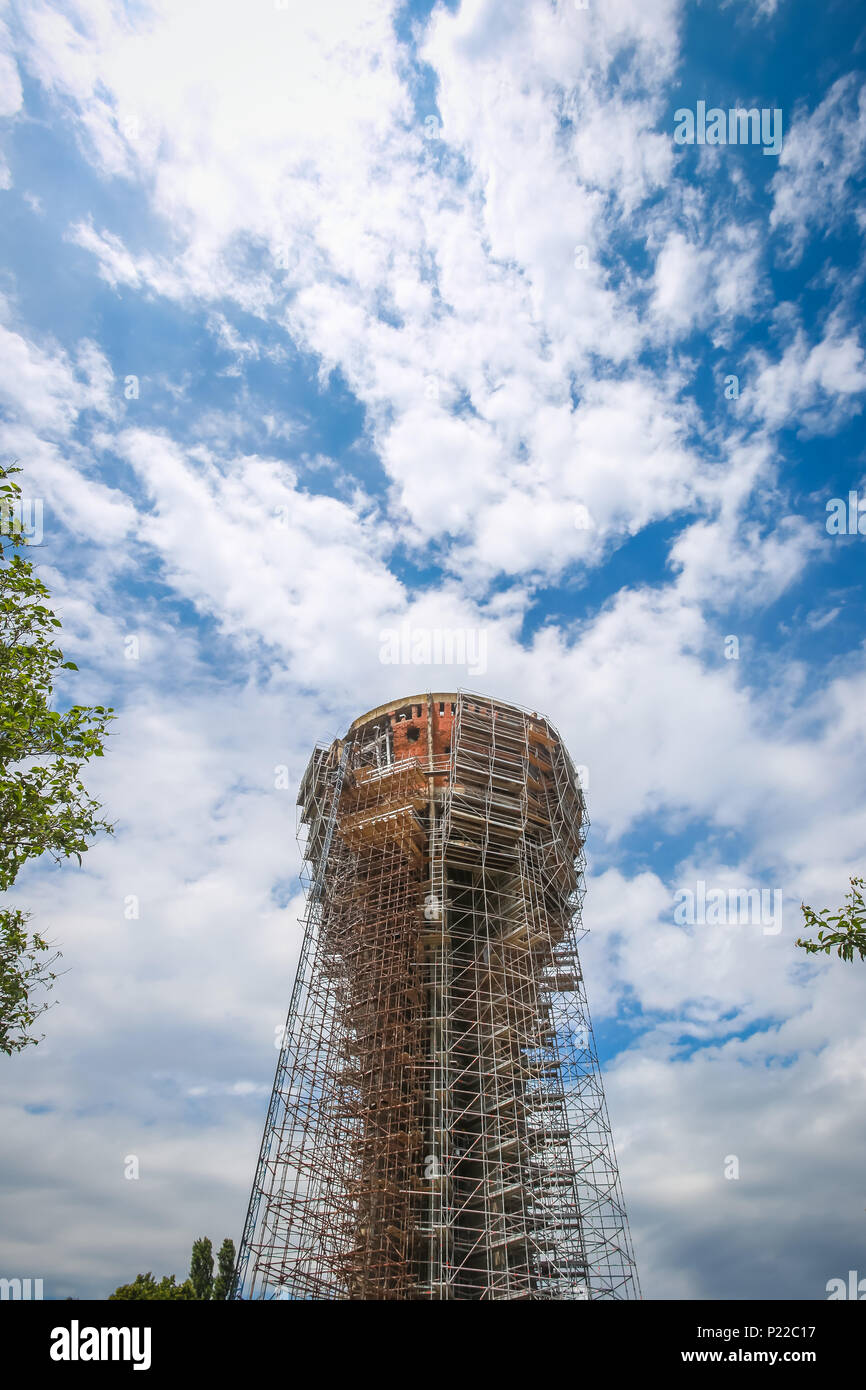 A low angle view of the Vukovar water tower under construction and intended to be a memorial place in Vukovar, Croatia. It is a symbol of the city suf Stock Photo
