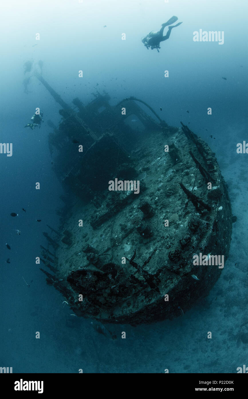 underwater ship wreck with scuba divers Stock Photo
