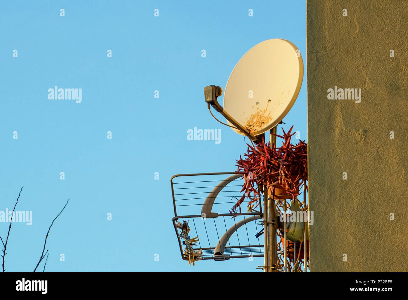 Old rusty satellite antenna on the wall Stock Photo