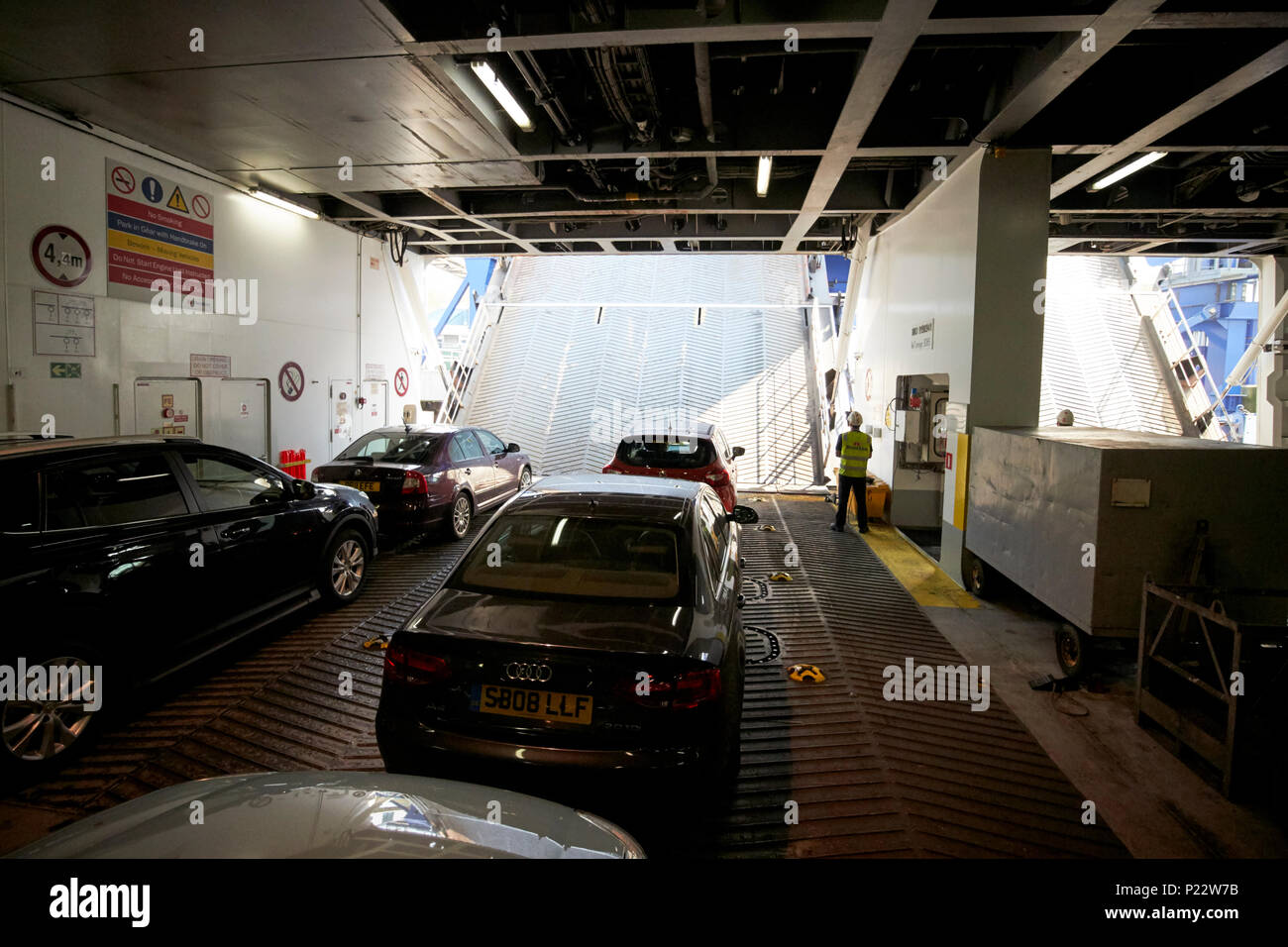lowering unloading ramps in front of cars on the vehicle deck of an irish sea stena line ferry in the uk Stock Photo